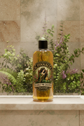 Resurect Me Shampoo displayed in a luxurious shower setting with botanical plants